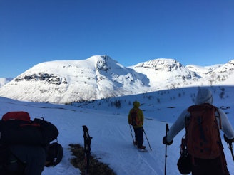 Snowboarding towards Camp Tamok with ski poles in hand.jpeg